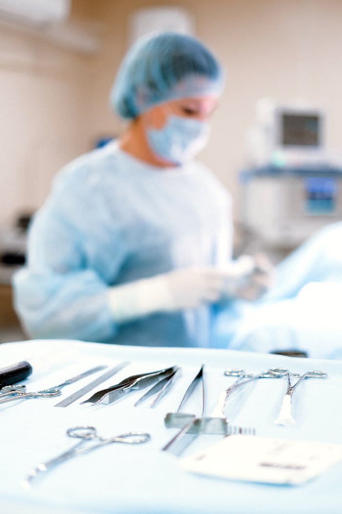 pexels photo 4586989 A medical professional in a sterile environment with surgical tools ready for operation.